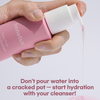Hand holding a pink cleanser bottle with text about mild acid moisture serum cleanser.